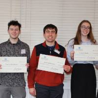 Students standing with monetary awards